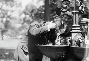 Bystanders Prints: Cooling his head - N.Y. on hot day, between c1910 and c1915. Creator: Bain News Service