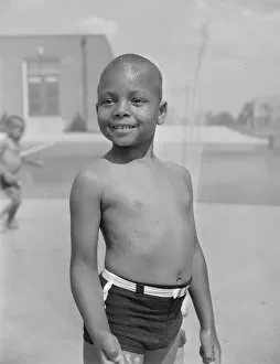 Swimming Gallery: Cooling off under the community sprayer, Frederick Douglass housing project, Anacostia, D.C, 1942