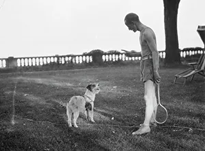 Squash Prints: Cosgrave, Mr. with dog, outdoors, not before 1917. Creator: Arnold Genthe