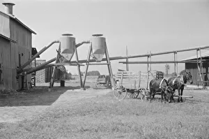 Cotton Gin Prints: Cotton gin and wagons, Vicinity of Moundville, Alabama, 1936. Creator: Walker Evans