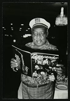 Count Basie Gallery: Count Basie reading a copy of Crescendo magazine at the Grosvenor House Hotel, London, 1979