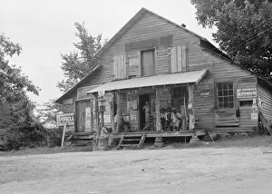 Porch Gallery: Country store on dirt road, Sunday afternoon, near Gordenton, North Carolina, 1939