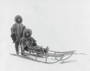 Dog Sled Prints: Couple on dog sled, between c1900 and 1927. Creator: Lomen Brothers
