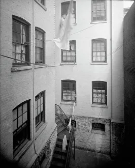 Clothes Line Prints: Court of tenement, New York City, between 1900 and 1910. Creator: Unknown