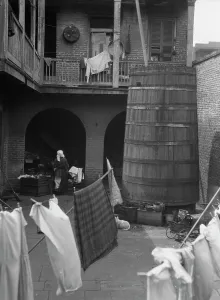 Clothes Line Prints: Courtyard with hanging laundry, New Orleans, between 1920 and 1926. Creator: Arnold Genthe