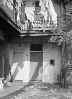 Clothes Line Prints: Courtyard, New Orleans, between 1920 and 1926. Creator: Arnold Genthe