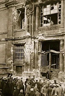 Upheaval Prints: A crowd of men gathered in front of a ruined building