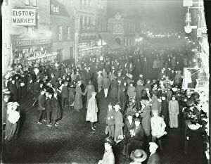 Deptford Gallery: Crowds in Deptford High Street shopping after dark, London, 1913