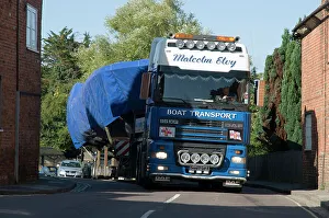 Truck Prints: DAF 95 XF wide load truck carrying a life boat through a small village