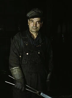 Blacksmiths Shop Gallery: Daniel Anastazia, blacksmiths helper, Rock Island R.R. Blue Island, Ill. 1943. Creator: Jack Delano