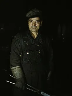 Daniel Anastazia, blacksmiths helper... roundhouse of the Rock Island R.R. Blue Island, Ill. 1943. Creator: Jack Delano