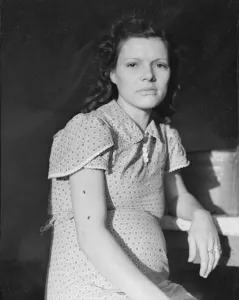 Migration Collection: Daughter of migratory family in FSA labor camp, Calpatria, Imperial Valley, California, 1939
