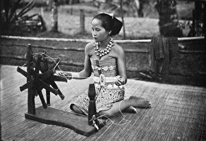 Sea Dayaks Gallery: A Dayak girl at her spinning wheel, 1902