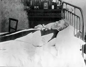 Single Bed Prints: A dead man, wearing robes, lying on his deathbed, (1900?). Creator: Unknown