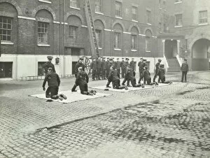 Unconscious Gallery: Demonstrating how to pick up an unconscious person, London Fire Brigade Headquarters, London, 1910