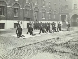 Firefighting Prints: Demonstrating how to pick up an unconscious person
