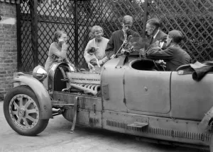 Bugatti Prints: Denis Evans inspecting the plugs of his Bugatti Type 43 2262cc. Artist: Bill Brunell