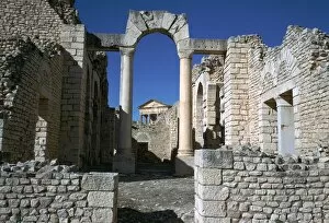 Dougga Gallery: Distant Roman capitol of Dougga seen through an arch, 2nd century