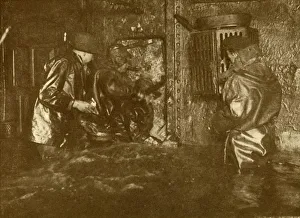 Divers Plugging A Leak During Salvage Operations Waist-Deep In Water On the Lower Divers Plugging A Leak During Salvage Operations Waist-Deep In Water On the Lower