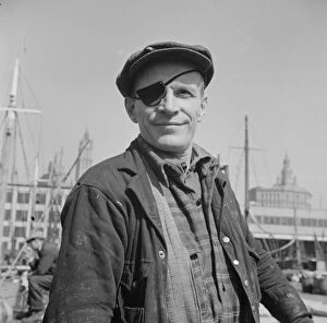 Dockers Gallery: Dock stevedore at the Fulton fish market, New York, 1943. Creator: Gordon Parks