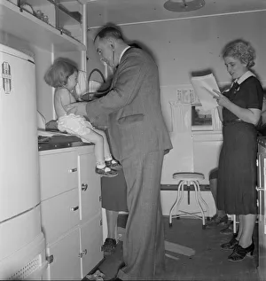 Crying Collection: Doctor examining children in trailer clinic, FSA mobile camp, Klamath County, Oregon
