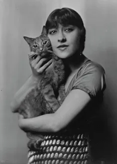 Twin Prints: Dolly sister, with Buzzer the cat, portrait photograph, 1916. Creator: Arnold Genthe