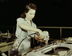 Women At War Gallery: Drilling a wing bulkhead for a transport plane at the Consolidated Air... Fort Worth, Texas, 1942