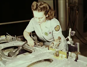 Drilling a wing bulkhead for a transport plane at the Consolidated Air... Fort Worth, Texas, 1942. Creator: Howard Hollem
