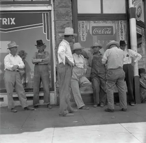 Americans Prints: Drought farmers line the shady side of the main street of the town