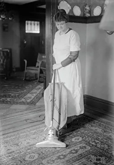Cleaning Prints: Dunlap vacuuming, between c1915 and c1920. Creator: Bain News Service