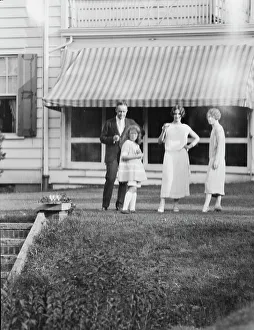 Group Portraits Prints: Dunning family, standing outside house, 1925 July 9. Creator: Arnold Genthe