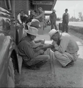 Cowboy Hat Prints: Dust bowl farmers of west Texas in town, 1937. Creator: Dorothea Lange