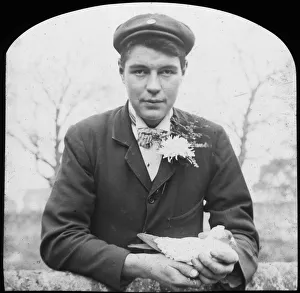 Buttonhole Prints: E Hack holding a pigeon, late 19th or early 20th century