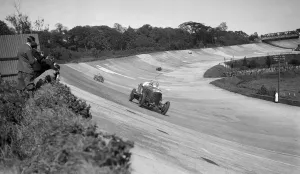 Eddie Hall Prints: Eddie Halls Bentley leading a Bugatti on the banking at Brooklands. Artist: Bill Brunell