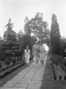 Garden Path Prints: Edge, Charles N. walking with Margaret Edge and another woman in his garden