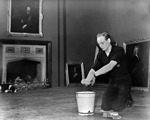 Beaulieu Collection: Edward, Lord Montagu of Beaulieu scrubbing floors in Palace House 1952. Creator: Unknown