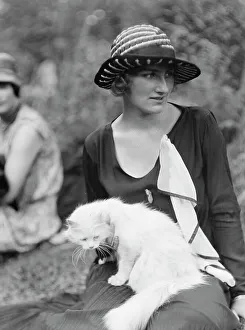 Egger, Gabrielle, Miss, with cat, seated outdoors, between 1926 and 1930. Creator: Arnold Genthe