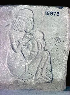 Egyptian relief of a woman suckling a child, 14th century BC