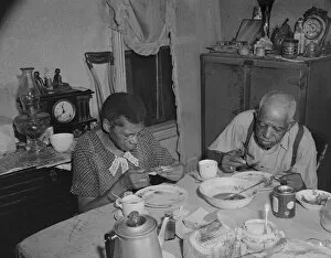 Elderly couple eating dinner at their home on Lamont Street, N.W. Washington, D.C. 1942. Creator: Gordon Parks