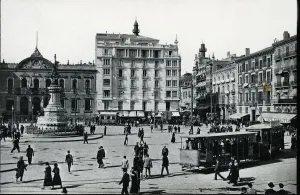 Electric Tram with trailer load circulating through the Plaza of the Constitution of Zaragoza