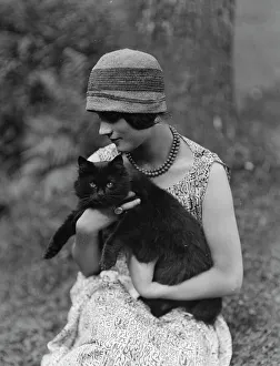 Cloche Hat Prints: Elizabeth Duncan dancer, with cat, portrait photograph, 1926 Creator: Arnold Genthe