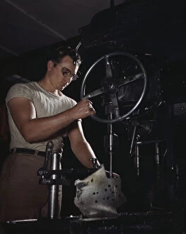 North American Aviation Gallery: An employee in the drill-press section of North Americans huge machine... Inglewood, Calif