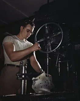 Assembly Line Methods Collection: An employee in the drill-press section of North Americans huge machine... Inglewood, Calif