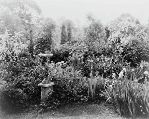 Sun Dial Prints: English lead figurine holding sundial