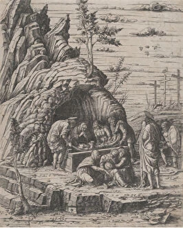 The Entombment of Christ who is being lowered by two men into a stone tomb before... ca