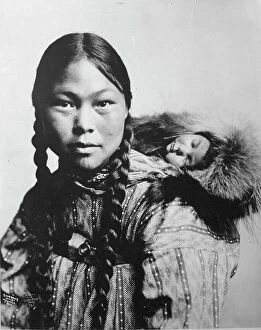 Infant Collection: Eskimo mother with child on back, c1906. Creator: Lomen Brothers