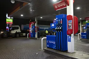 Garage Prints: Esso petrol station forecourt with tanker delivering fuel, 2020. Creator: Tim Woodcock
