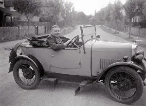FA Thatcher behind the wheel of a 1929 Triumph Super Seven open four-seater. Artist: Bill Brunell