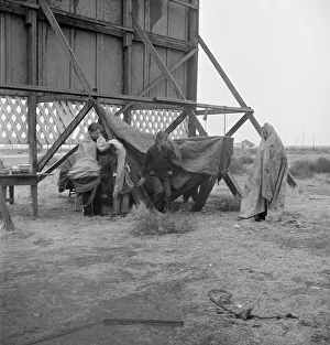 Makeshift Prints: One of three families camped behind a billboard on U