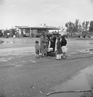 Displaced Persons Collection: Family of homeless, walking people are left at the edge of the next town, 1939